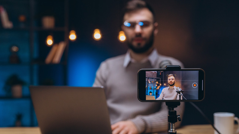 Content creator shooting a video using a phone