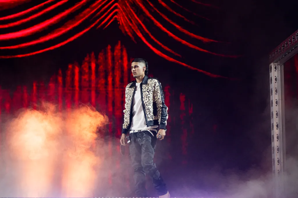 Image may contain Performer Person Solo Performance Adult Clothing and Coat