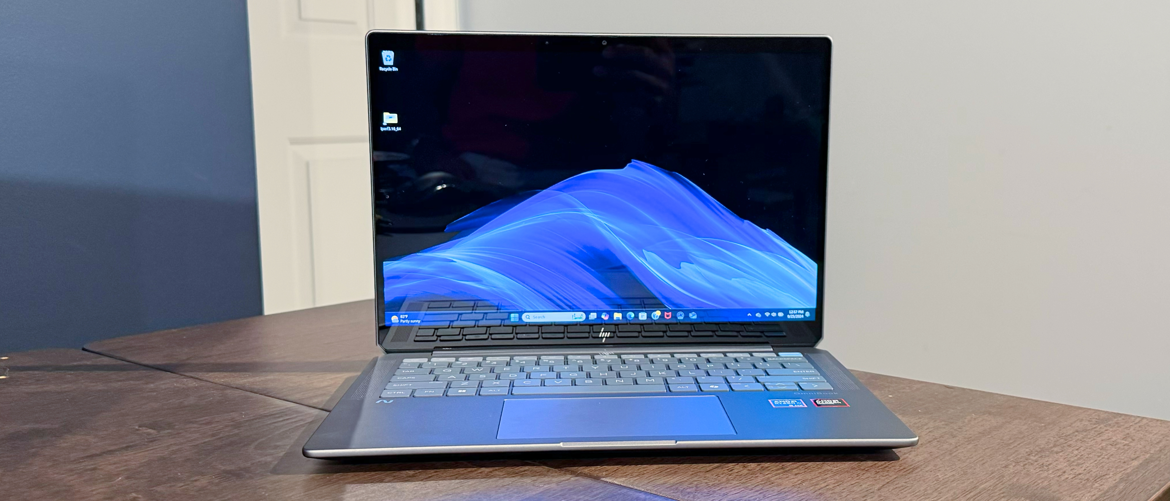 The HP OmniBook Ultra on a table. The table has no frills, just like the laptop, which excels at packing power into a plain design.