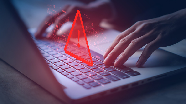 An illustration suggesting a person may be dealing with a malicious program on a computer.
