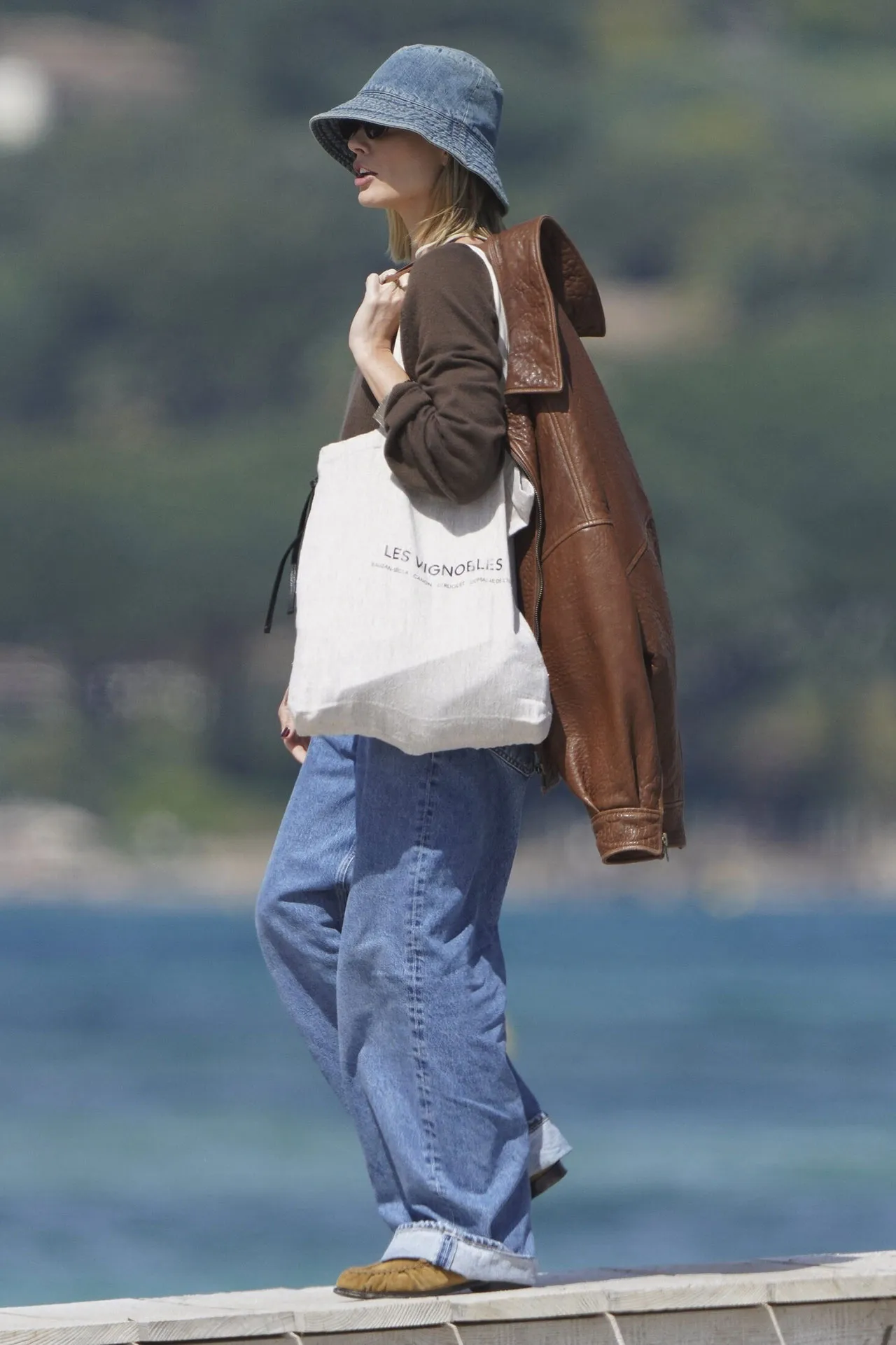 Image may contain Margot Robbie Clothing Pants Coat Jacket Jeans Accessories Bag Handbag Person and Blazer
