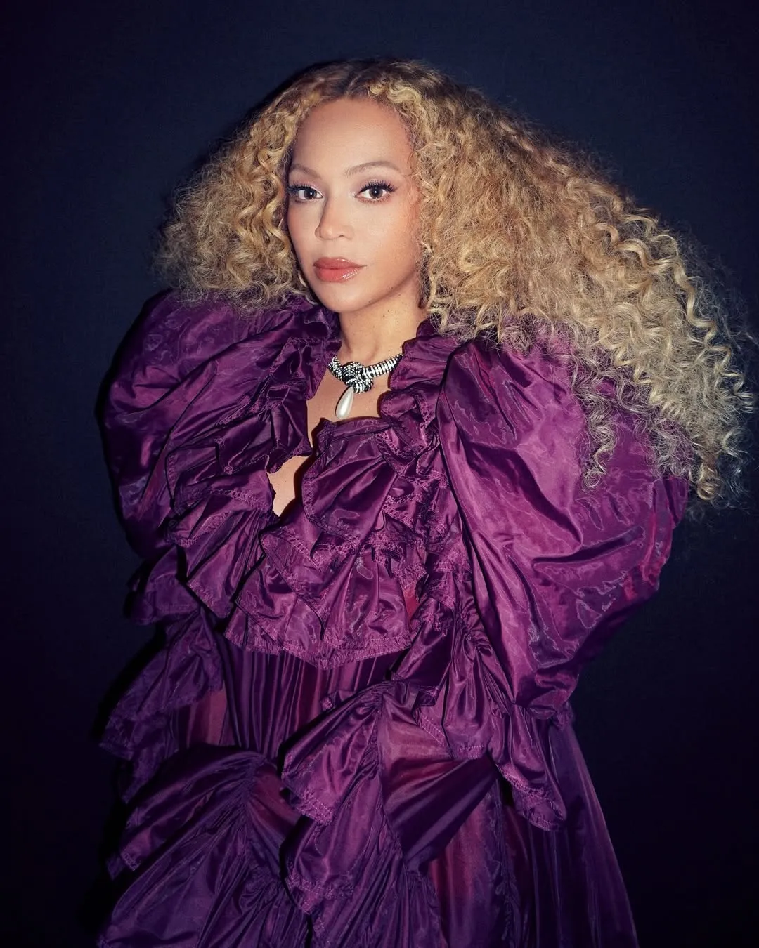 Image may contain Beyonc Purple Adult Person Clothing Dress Blonde Hair Face Head Photography and Portrait