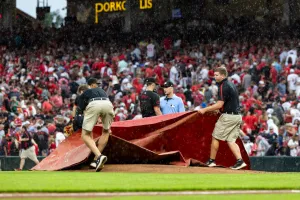 CINCINNATI, OHIO - JULY 5: Members of the grounds crew pull a tarp for rain during the fourth inning of the Cincinnati Reds home game against the Detroit Tigers at Great American Ball Park on July 5, 2024 in Cincinnati, Ohio. (Photo by Lauren Leigh Bacho/Getty Images)