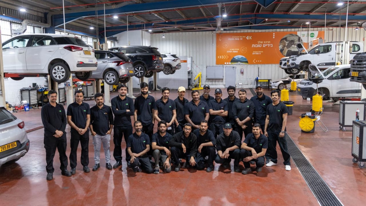 The central garage in Holon, alongside certified garage workers from India. The central garage in Holon, alongside certified garage workers from India.
