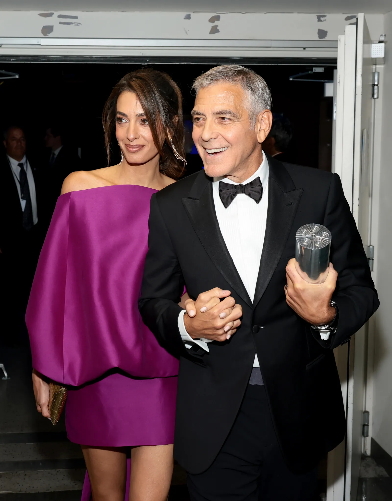 Image may contain George Clooney Amal Clooney Blazer Clothing Coat Jacket Adult Person Photobombing and Formal Wear