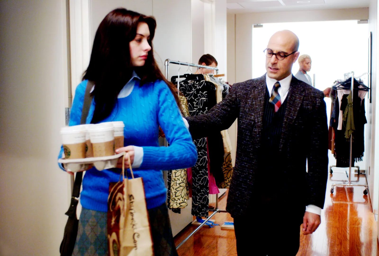 Image may contain Anne Hathaway Stanley Tucci Formal Wear Adult Person Dressing Room Indoors Room Clothing and Coat