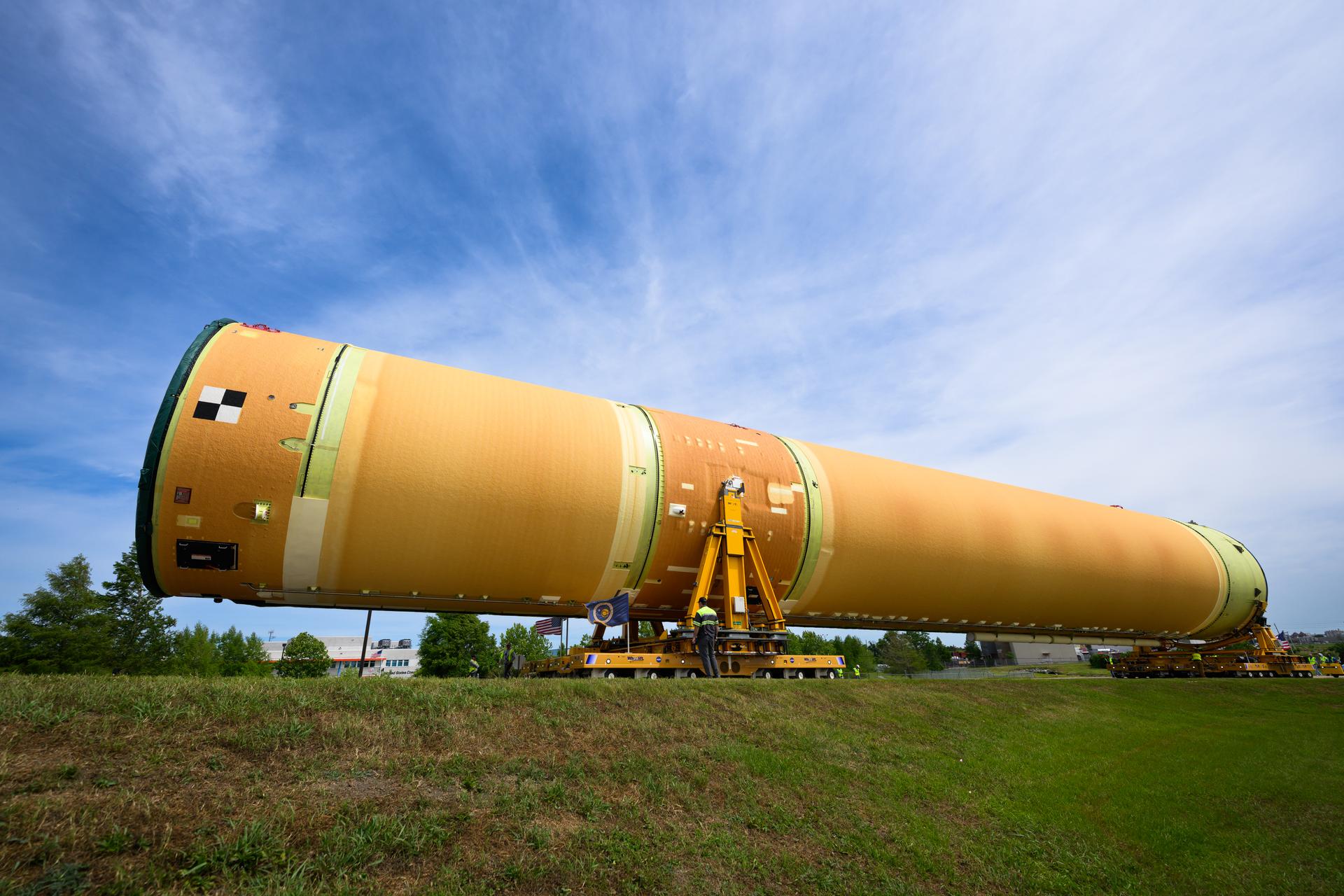 NASA moved the core stage, or the largest section, of the SLS (Space Launch System) rocket that will launch the crewed Artemis III mission in 2027 from the agency’s Michoud Assembly Facility to the agency’s Pegasus barge in New Orleans on April 20. The barge will ferry the top four-fifths – the section containing the liquid hydrogen tank, liquid oxygen tank, intertank, and forward skirt – of the SLS core stage to NASA’s Kennedy Space Center in Florida to complete outfitting and vertical integration.  Teams with NASA and Boeing, the SLS core stage lead contractor, used specialized transporters to guide the top four-fifths from the NASA rocket factory to Pegasus. Prior to the move, technicians added an engine section transportation simulator to the rocket stage for shipment to the Space Coast.  Next year’s Artemis III mission will launch astronauts to Earth’s orbit aboard the Orion spacecraft on top of SLS to test rendezvous and docking capabilities between Orion and commercial spacecraft needed to land Artemis IV astronauts on the Moon in 2028. NASA’s SLS is the only rocket capable of sending Orion, astronauts, and supplies to the Moon in a single launch.   Photo Credit: NASA/Eric Bordelon