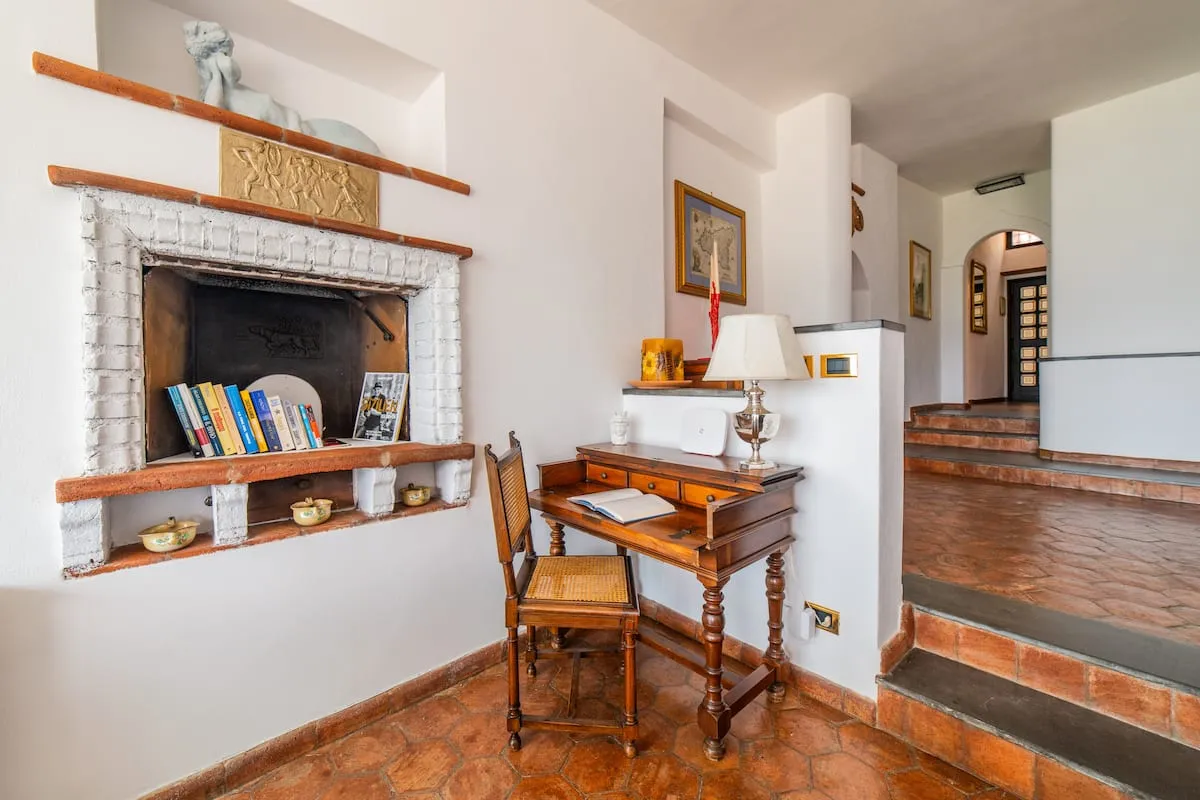 Image may contain Corner Book Publication Indoors Interior Design Lamp Floor Chair Furniture Fireplace and Art