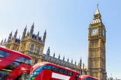 parliament buildings with buses going by 