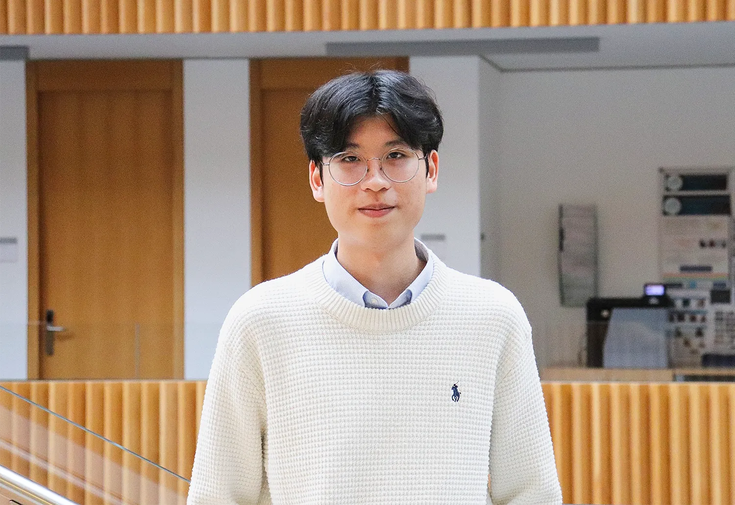 Image may contain Clothing Knitwear Sweater Adult Person Face Head Black Hair Hair Accessories and Glasses