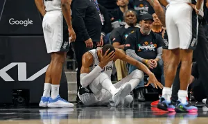 SAN ANTONIO, TX -APRIL 21: Victor Wembanyama #1 of the San Antonio Spurs holds his head after falling to the court against the Portland Trailblazers in the first half of Game Two of the Western Conference First Round NBA Playoffs at Frost Bank Center on April 21, 2026 in San Antonio, Texas.