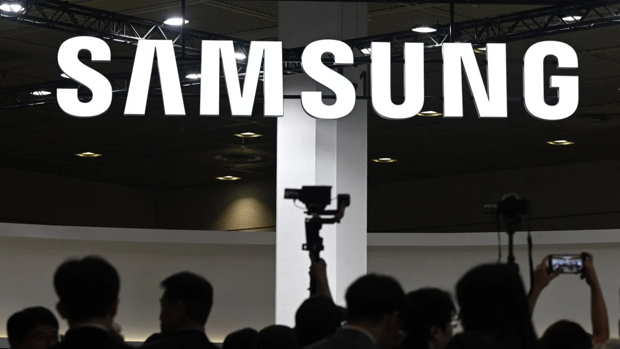 Visitors walk past the logo of Samsung Electronics during the 2026 World IT Show in Seoul on April 22, 2026