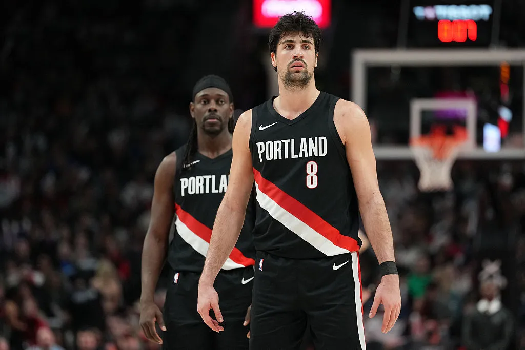 PORTLAND, OREGON - MARCH 27: Deni Avdija #8 and Jrue Holiday #5 of the Portland Trail Blazers look on during the second half against the Dallas Mavericks at Moda Center on March 27, 2026 in Portland, Oregon. NOTE TO USER: User expressly acknowledges and agrees that, by downloading and or using this photograph, User is consenting to the terms and conditions of the Getty Images License Agreement. (Photo by Soobum Im/Getty Images)