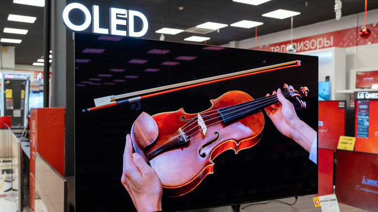 OLED in-store display showing violin on screen