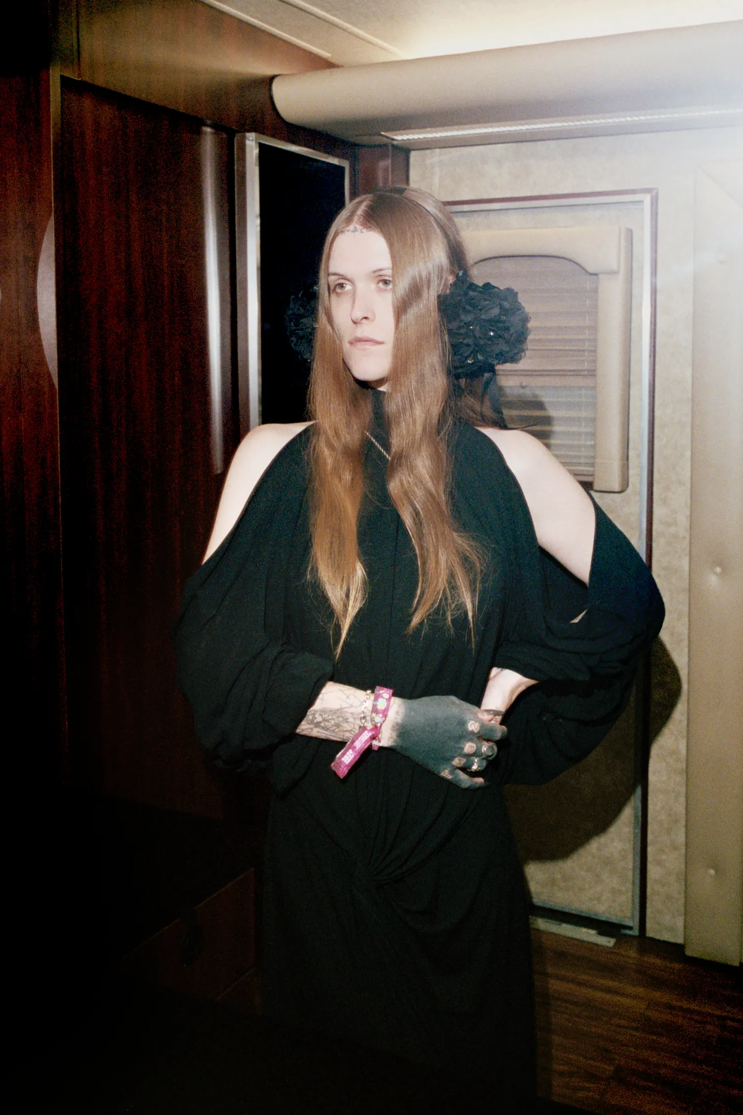 Image may contain Face Head Person Photography Portrait Clothing Dress Formal Wear Adult Door and Fashion