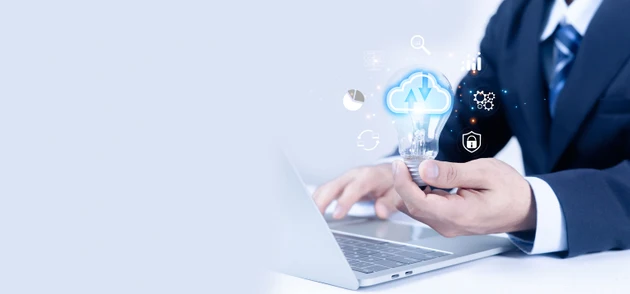 Businessman using laptop holding light bulb with cloud computing icons, data analytics, cybersecurity and digital technology concept, representing innovation, smart business solutions.