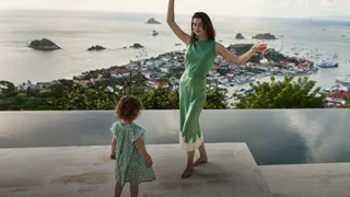 Image may contain Face Head Person Photography Portrait Water Waterfront Child Adult Clothing Dress and Beachwear