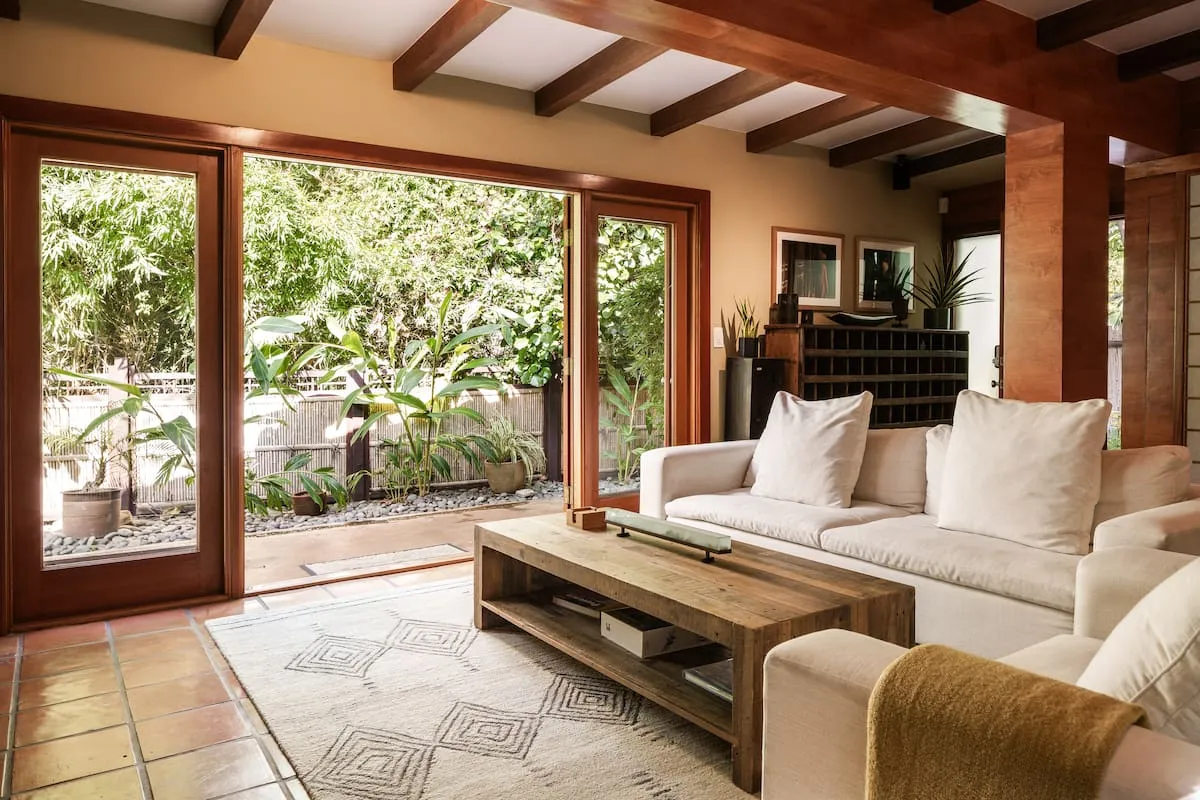 Image may contain Indoors Interior Design Plant Architecture Building Furniture Living Room Room and Couch