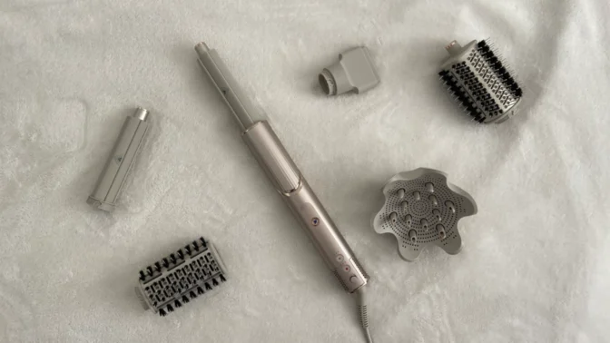 the shark flexstyle and its attachments laid out on a white blanket