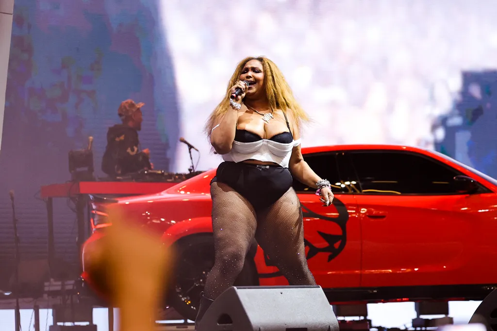 Image may contain Lizzo Adult Person Performer Solo Performance Electrical Device Microphone Car and Transportation