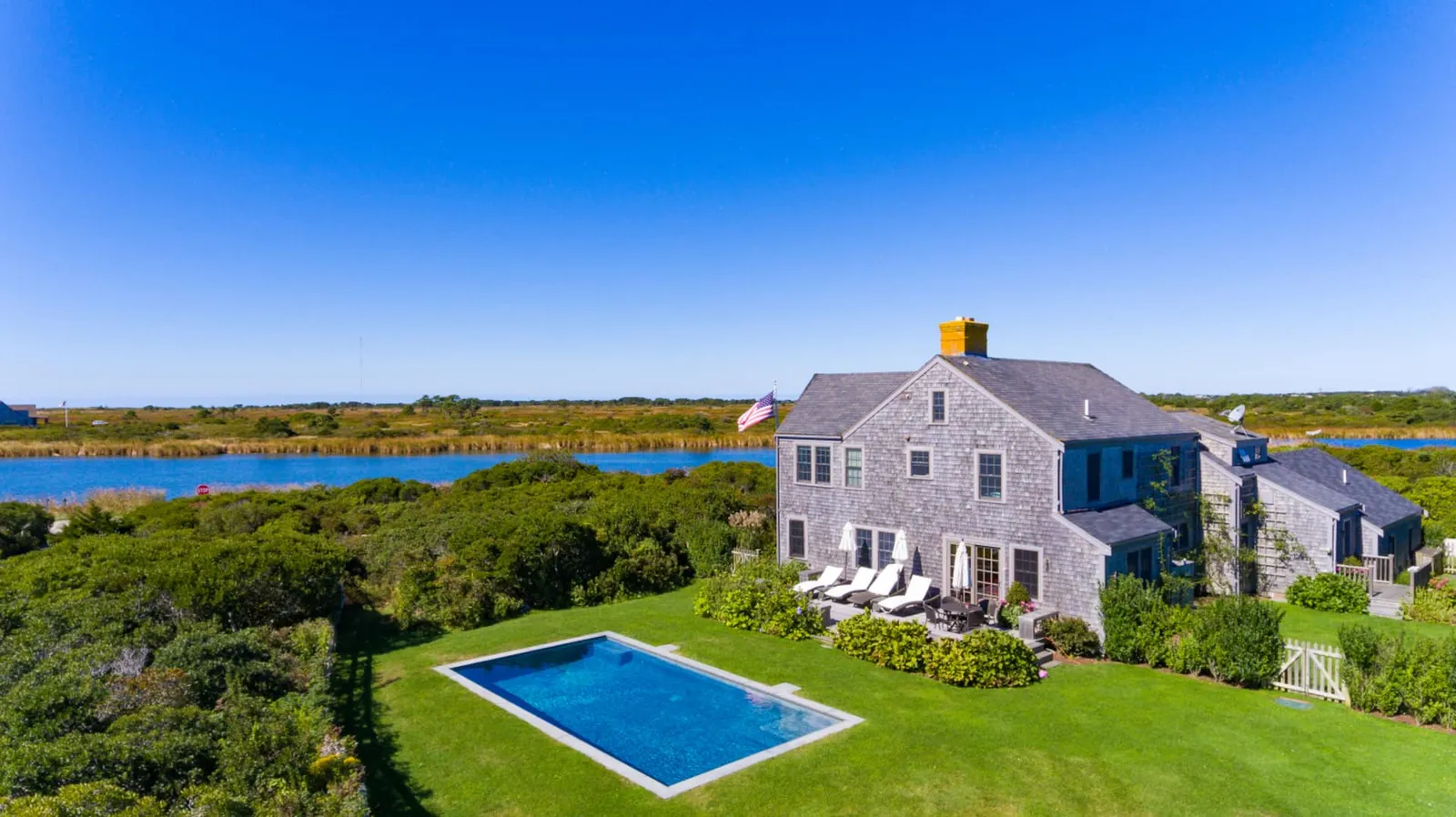 Image may contain Pool Water Swimming Pool Architecture Building House Housing Villa Outdoors Grass and Plant