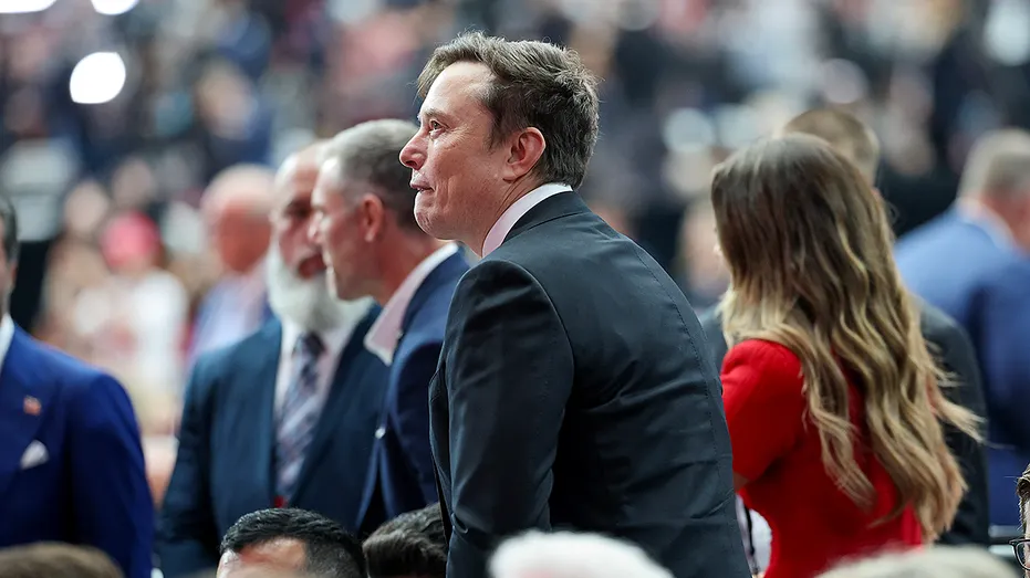 Elon Musk surrounded by people