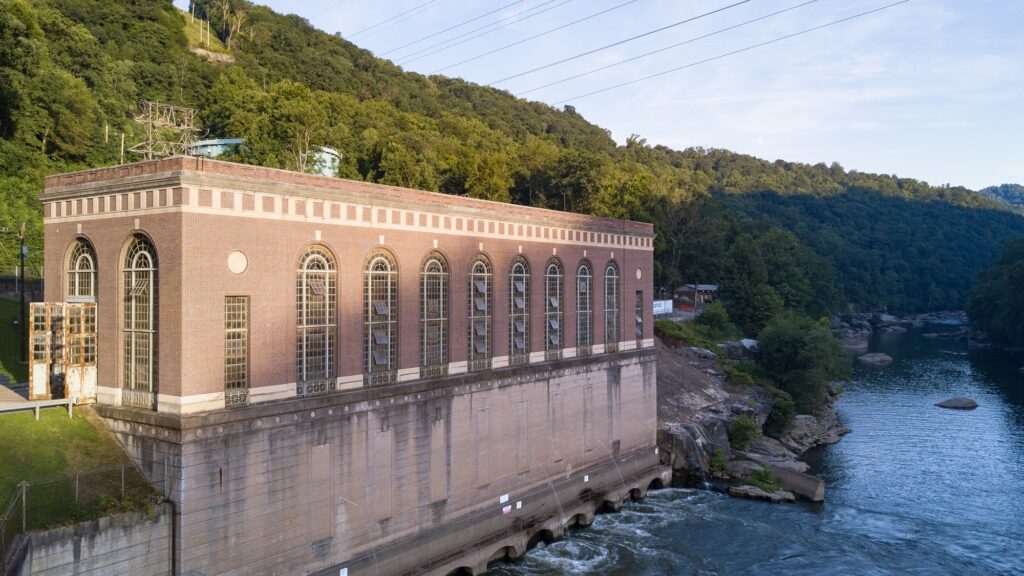 A building on the river’s edge, with tall arched windows and more arches at the water level.