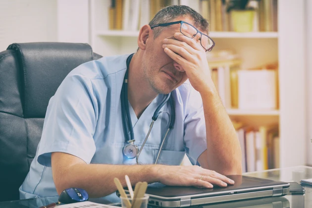 Overworked doctor in his office