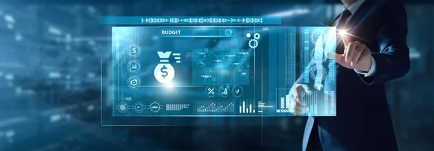Businessman points at a holographic budget and finance interface with money bag and charts.