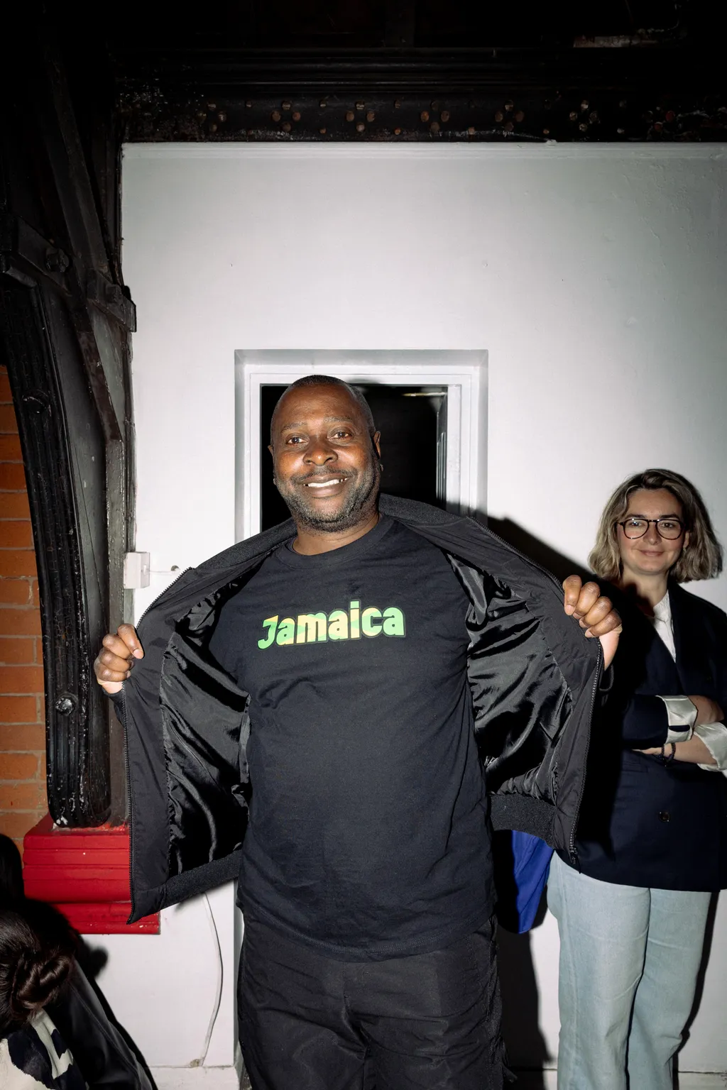 Image may contain Clothing TShirt Face Head Person Photography Portrait Coat Jacket Shirt Photobombing and Adult