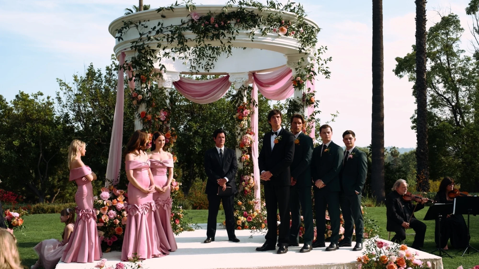 A wedding party awaits the bride.