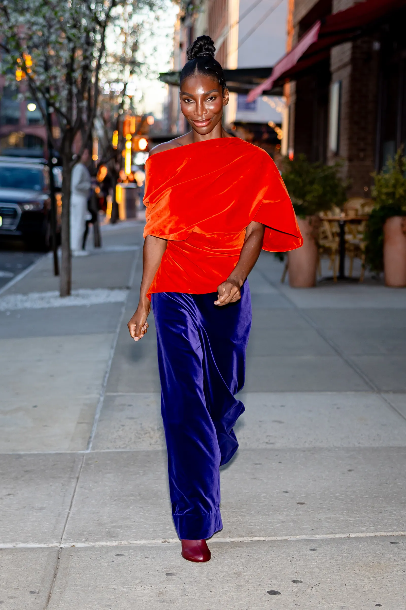 Image may contain Michaela Coel Clothing Sleeve Person Standing Adult Pants Car Transportation Vehicle and Face