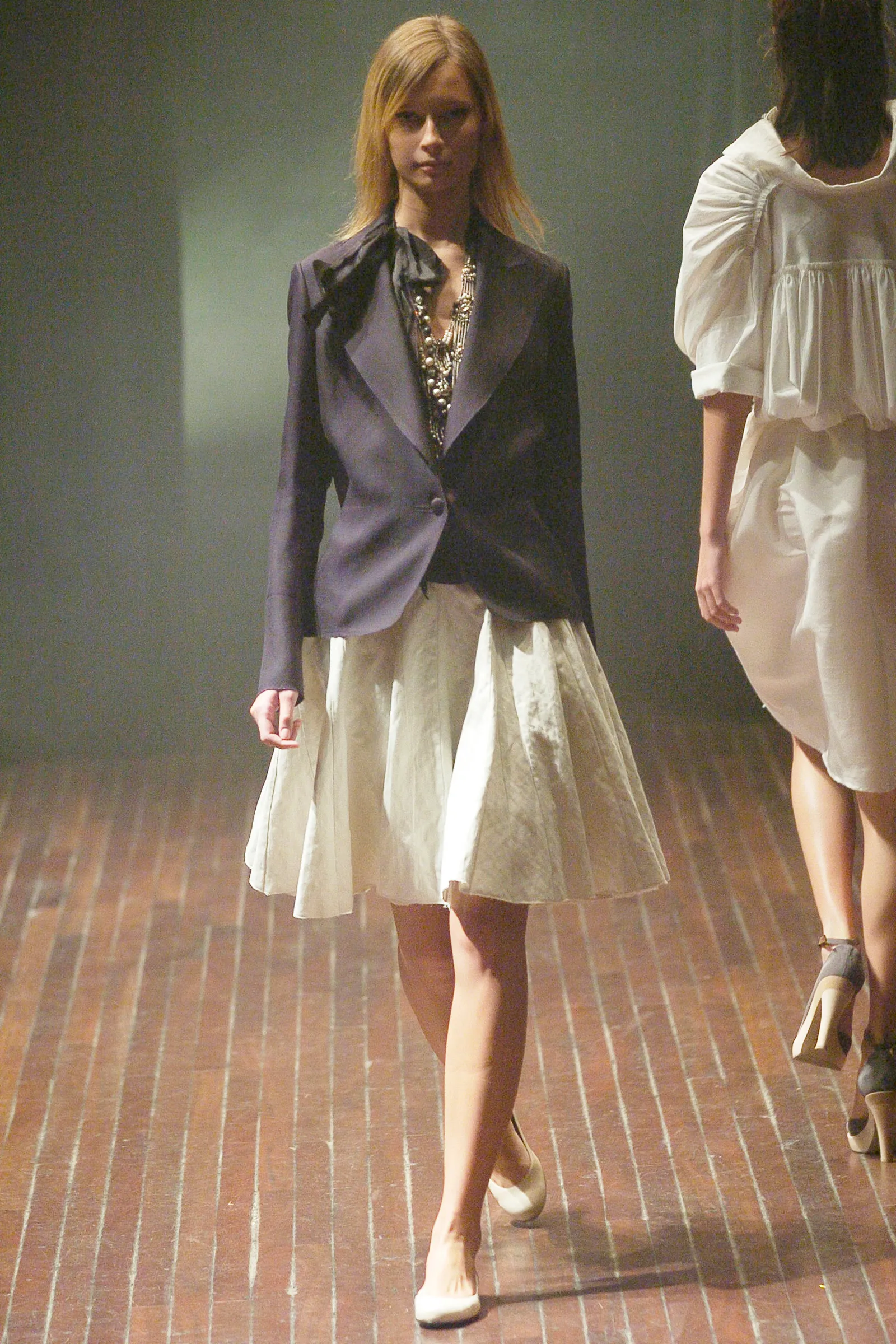 Image may contain Blazer Clothing Coat Jacket Skirt Adult Person Footwear High Heel Shoe Accessories and Jewelry