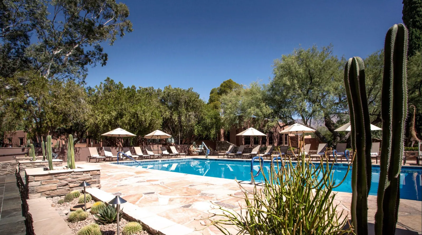 Image may contain Architecture Building Hotel Resort Summer Pool Water Swimming Pool Nature Outdoors and House