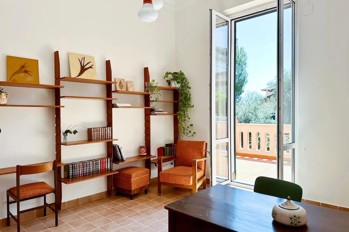 Image may contain Chair Furniture Desk Table Plant Indoors Interior Design Architecture Building and Living Room