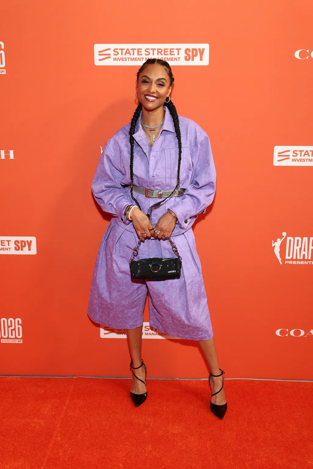 Image may contain Tasha Marbury Fashion Accessories Bag Handbag Clothing Coat Adult Person Face Head and Footwear