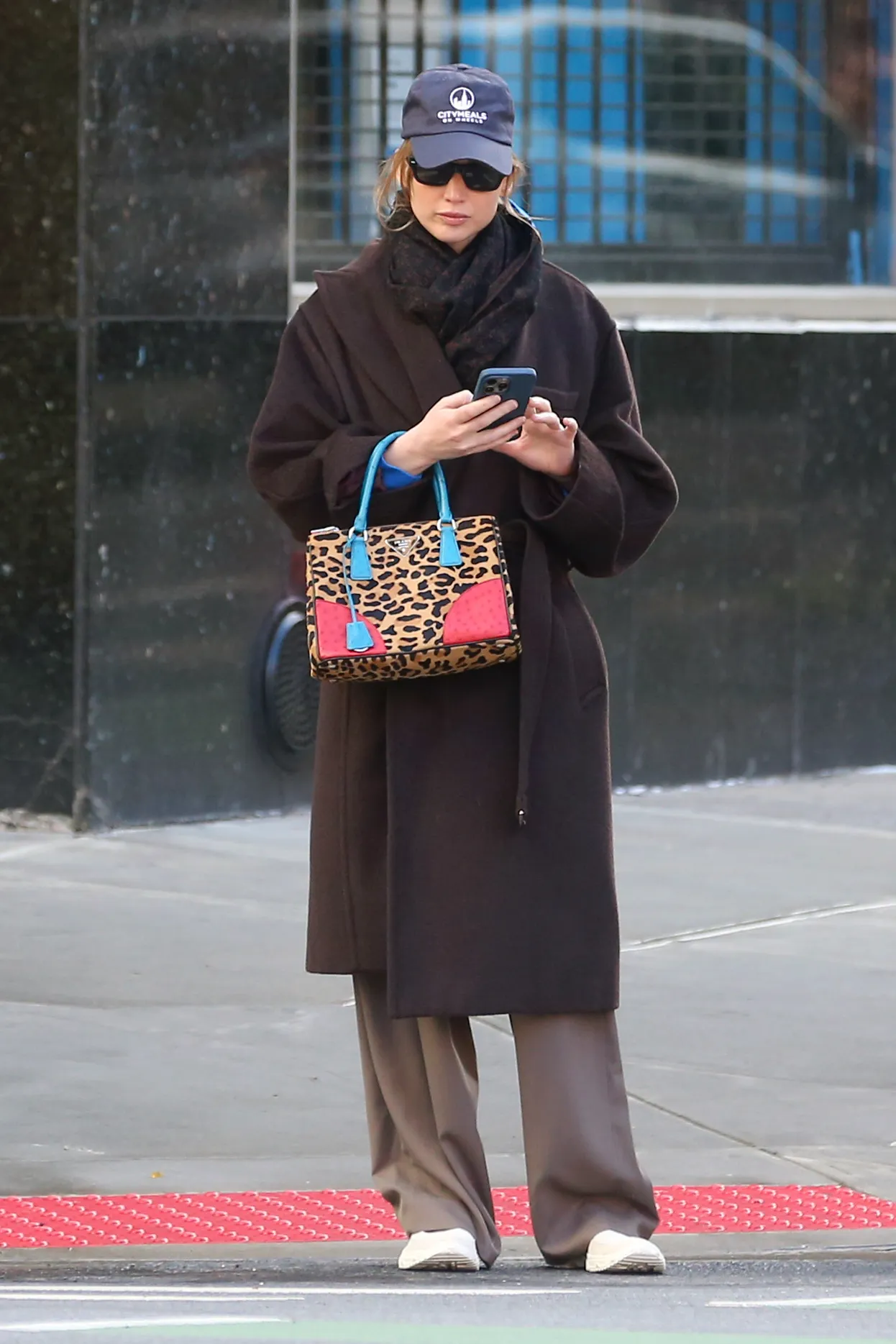 Image may contain Jennifer Lawrence Accessories Bag Handbag Purse Clothing Coat Person Baseball Cap Cap and Hat
