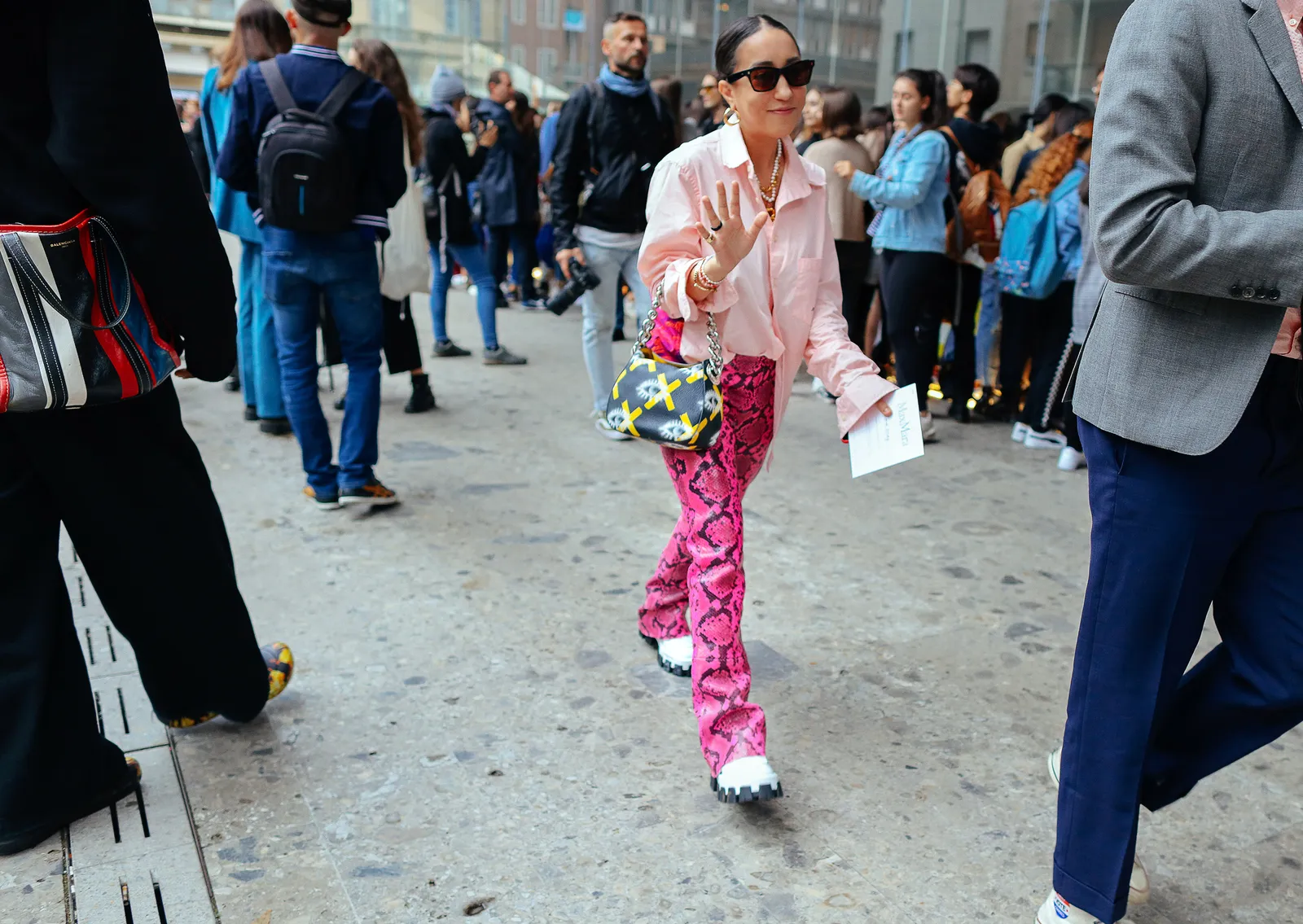 This image may contain Human Person Clothing Apparel Pedestrian Sunglasses Accessories Accessory Shoe and Footwear