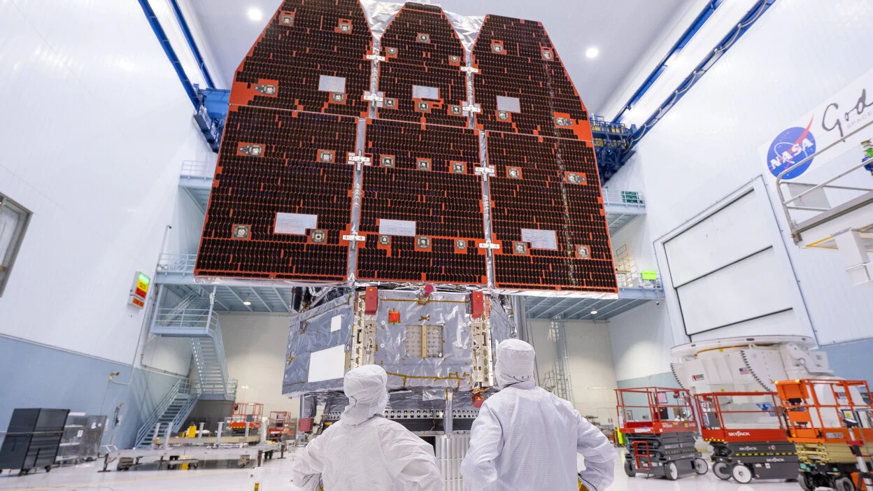Technicians looking at the completed Nancy Grace Roman Space Telescope