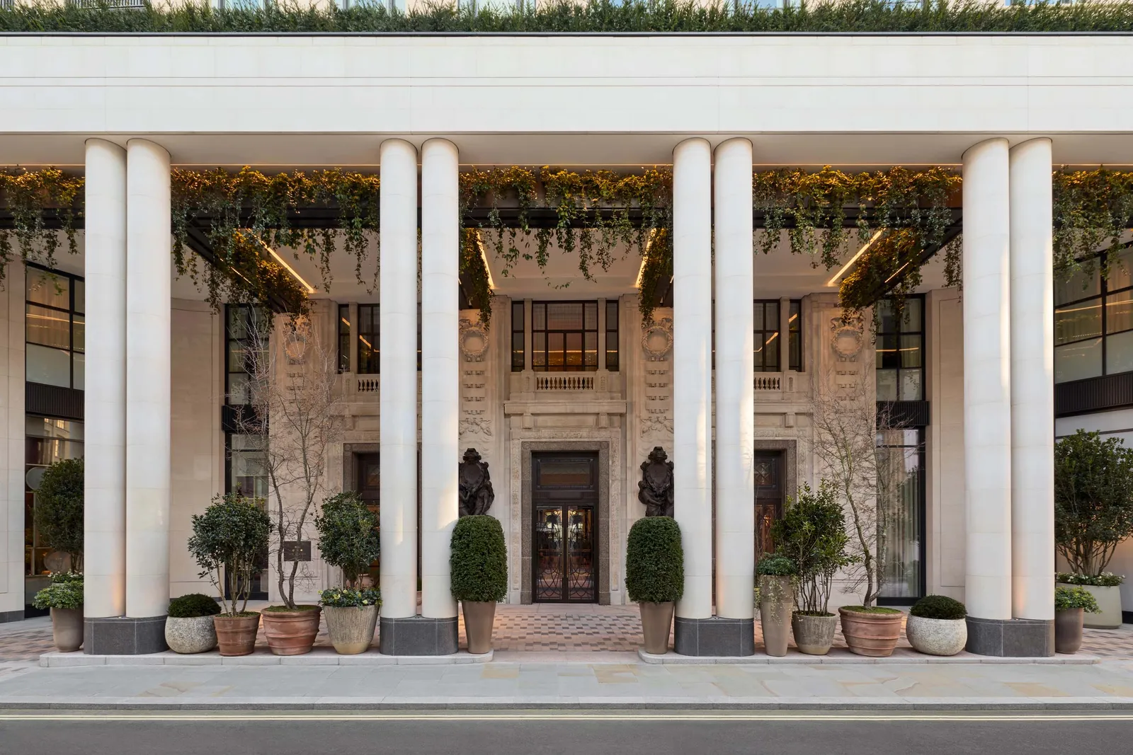 Image may contain Architecture Building House Housing Portico Plant and Person
