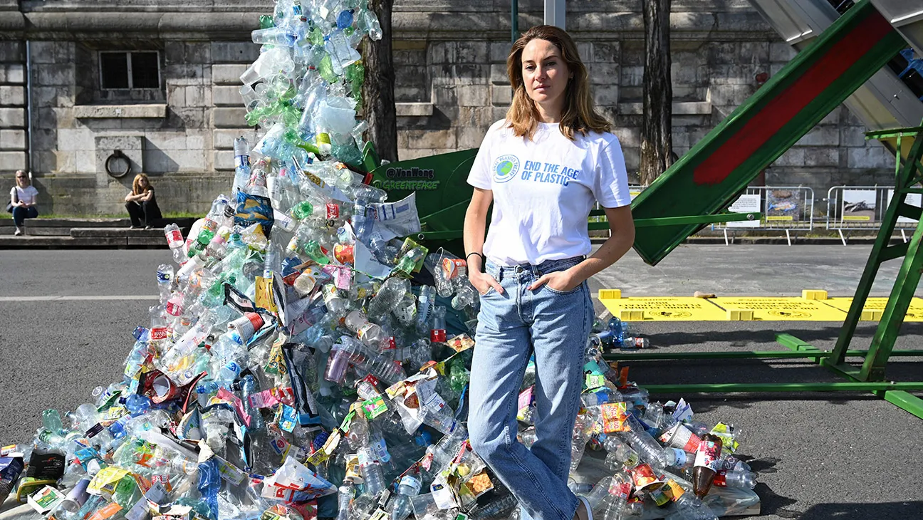 US Emmy-nominated actress and activist Shailene Woodley poses next to Canadian artist and activist Benjamin Von Wong's 5-meter tall art installation the PerpetualPlastic Machine during its unveiling ceremony on the banks of the Seine River in Paris on May 27, 2023, for the Global Plastics Treaty to stop runaway plastic and use.