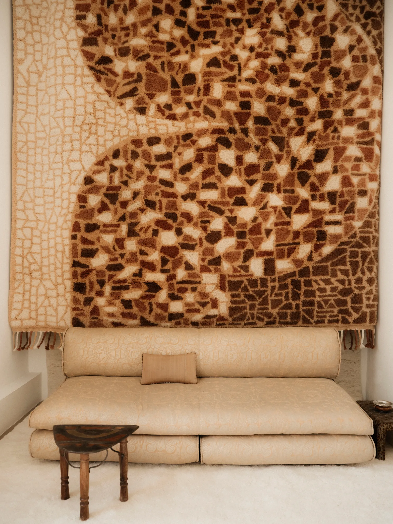 Image may contain Home Decor Indoors Interior Design Rug Couch Furniture Architecture Building Wall and Cushion