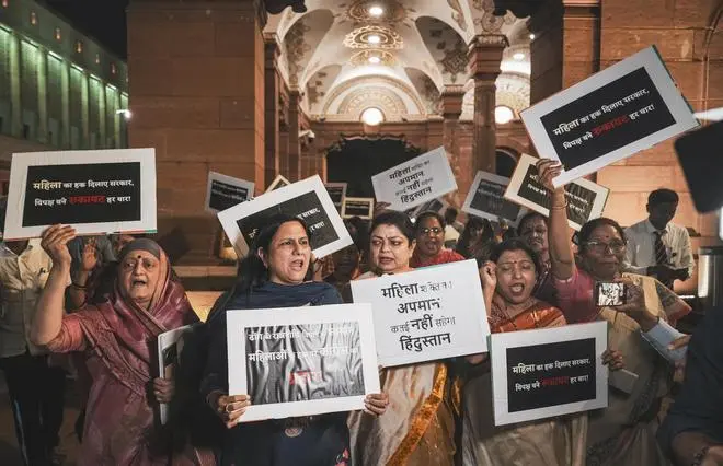 BJP MPs, including Kamaljeet Sehrawat, and others raise slogans during a protest, after the Constitution Amendment Bill to implement reservation for women in legislatures in 2029 and increase the number of seats of the Lok Sabha was defeated, during the Special session of Parliament, in New Delhi, Friday, April 17, 2026.