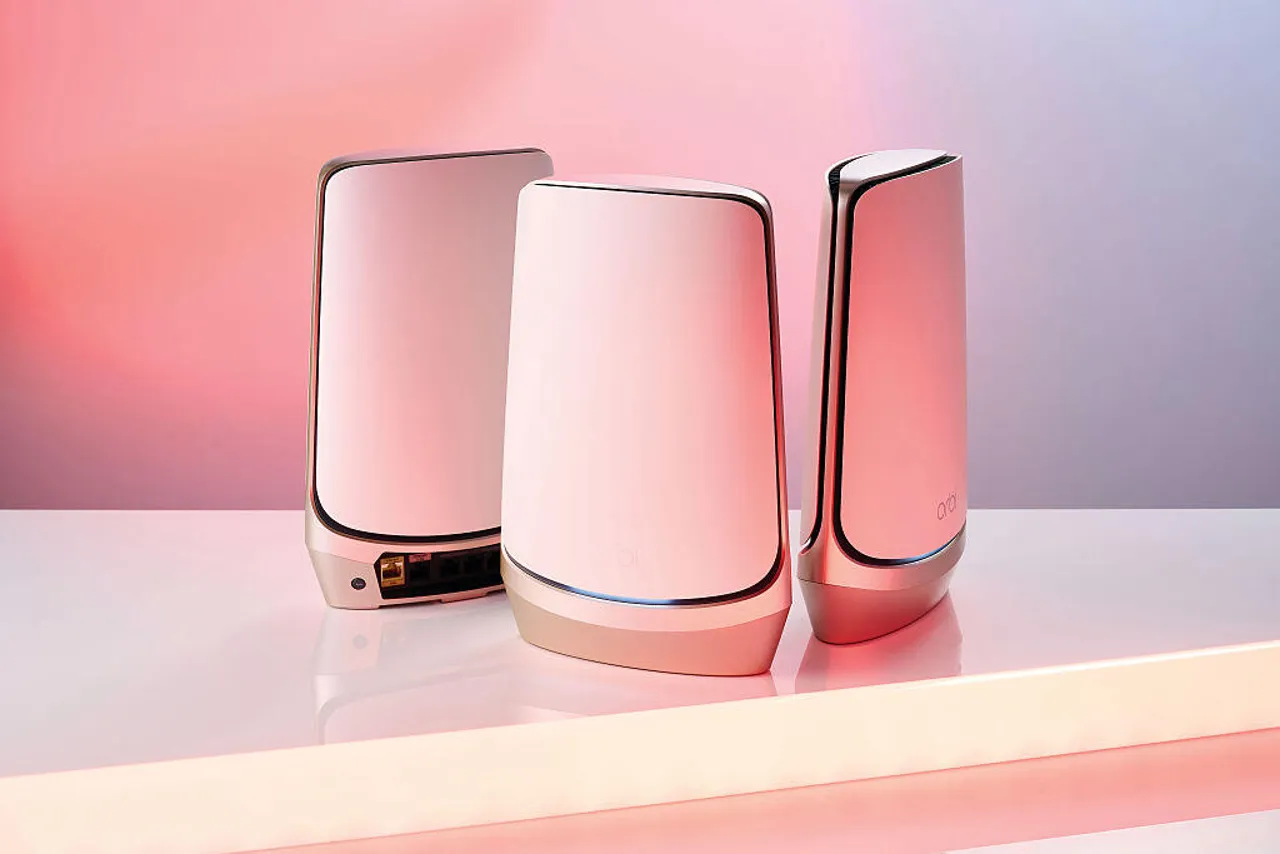 Detail of Orbi home WiFi mesh network system, on pink background.