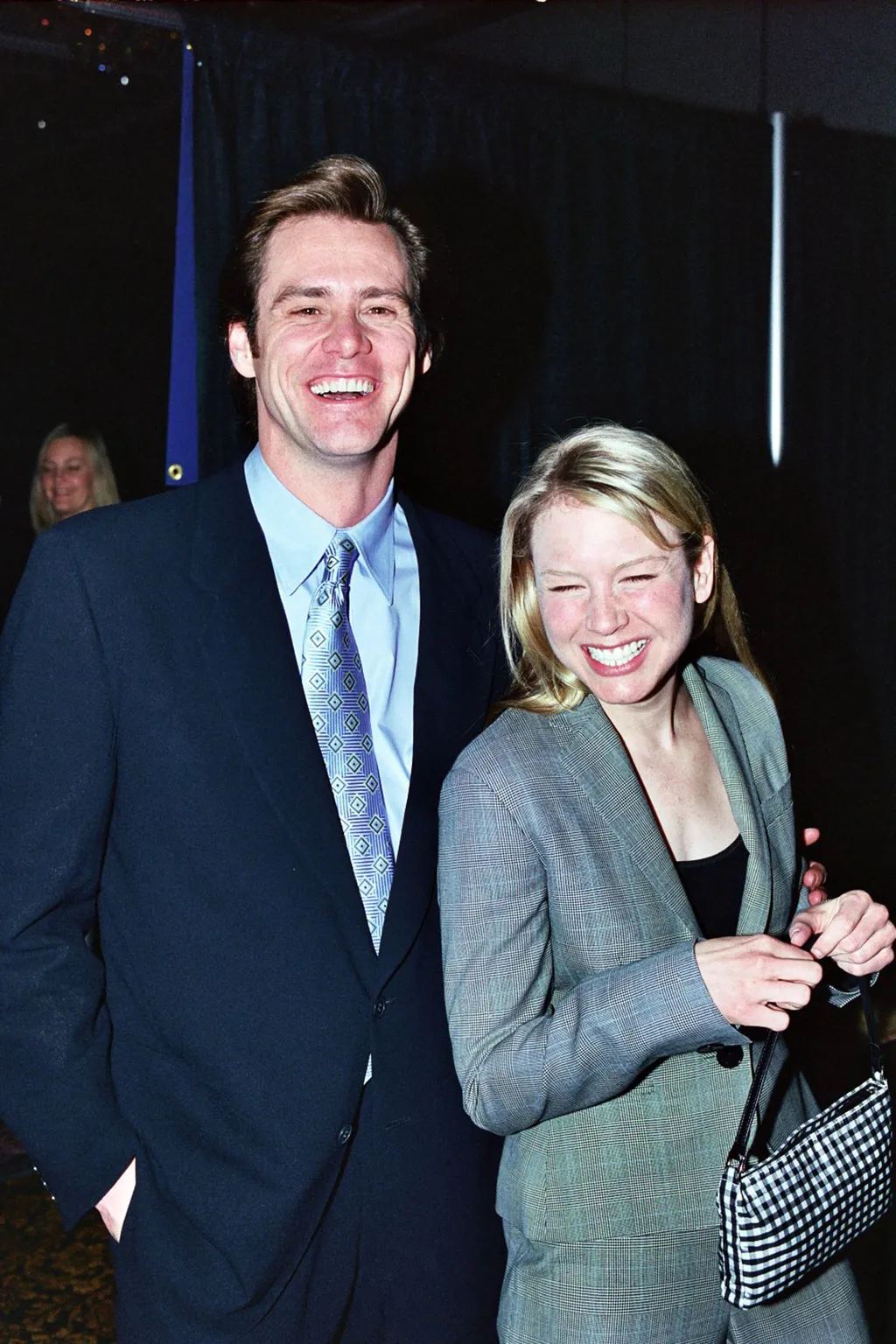 Image may contain Jim Carrey Rene Zellweger Lorraine Stanley Blazer Clothing Coat Jacket and Accessories