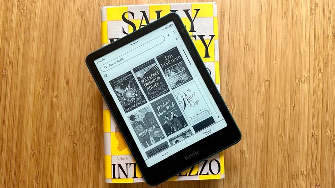 A Kindle Paperwhite on top of a copy of Intermezzo by Sally Rooney