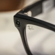 A close-up image of a small camera in the corner of the Ray-Ban Meta glasses frame.