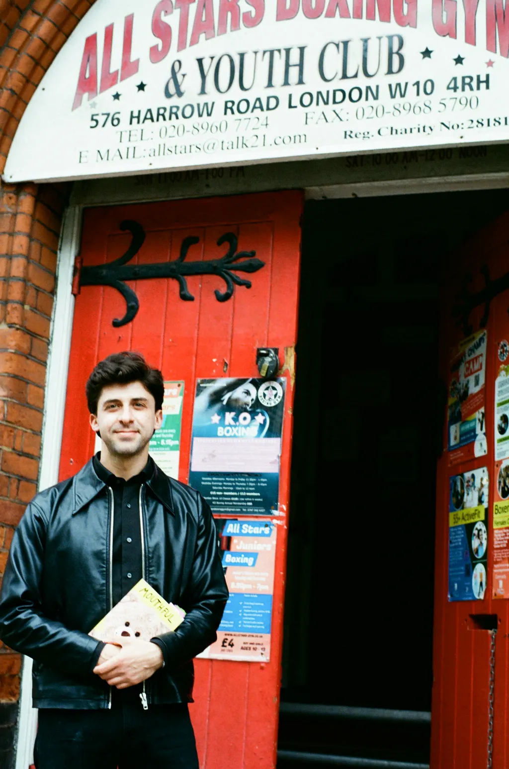 Image may contain Clothing Coat Jacket Face Head Person Photography Portrait Adult Architecture and Building
