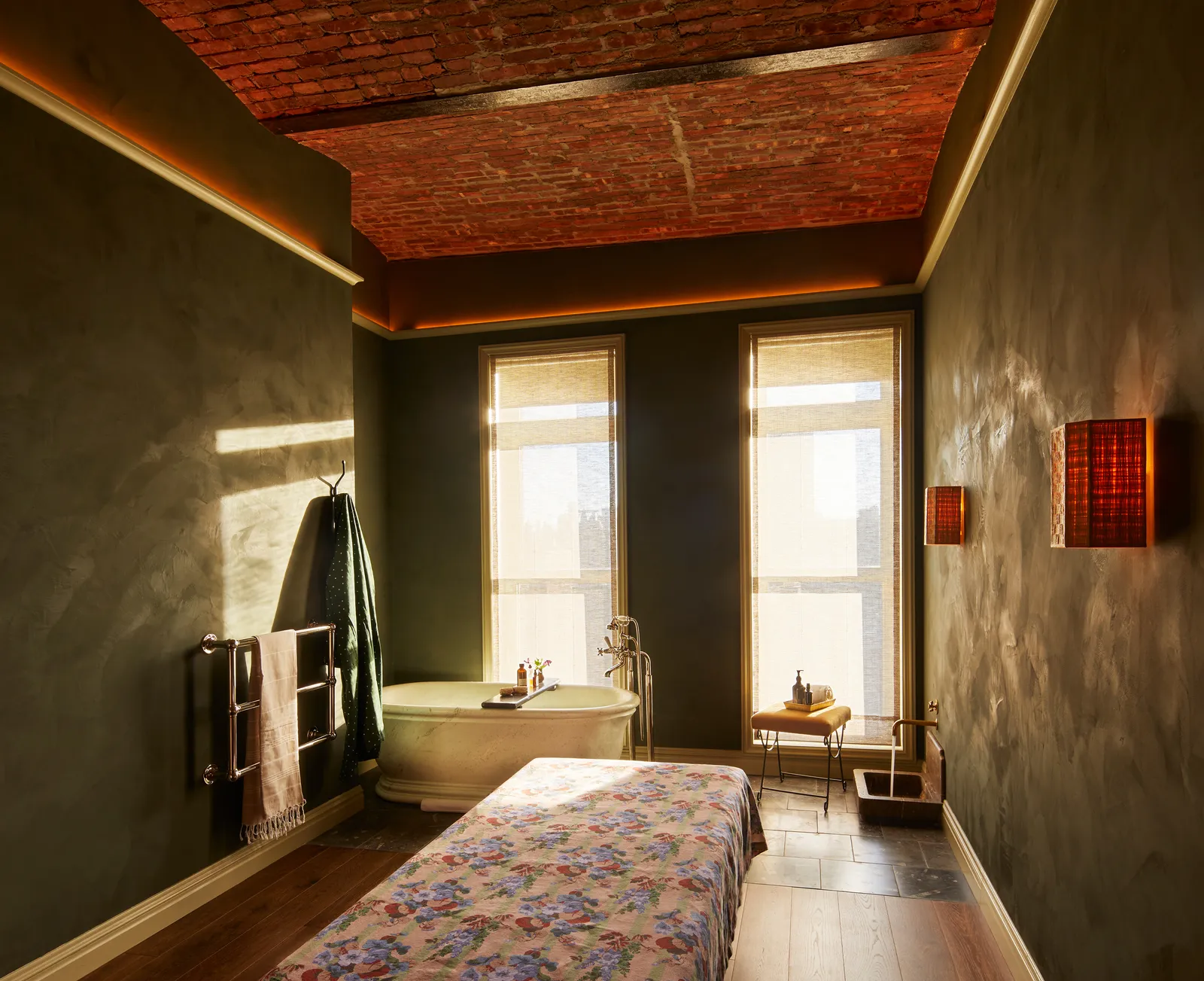 Image may contain Indoors Interior Design Bed Furniture Bathing Bathtub Person Tub Wood Lamp Desk and Table