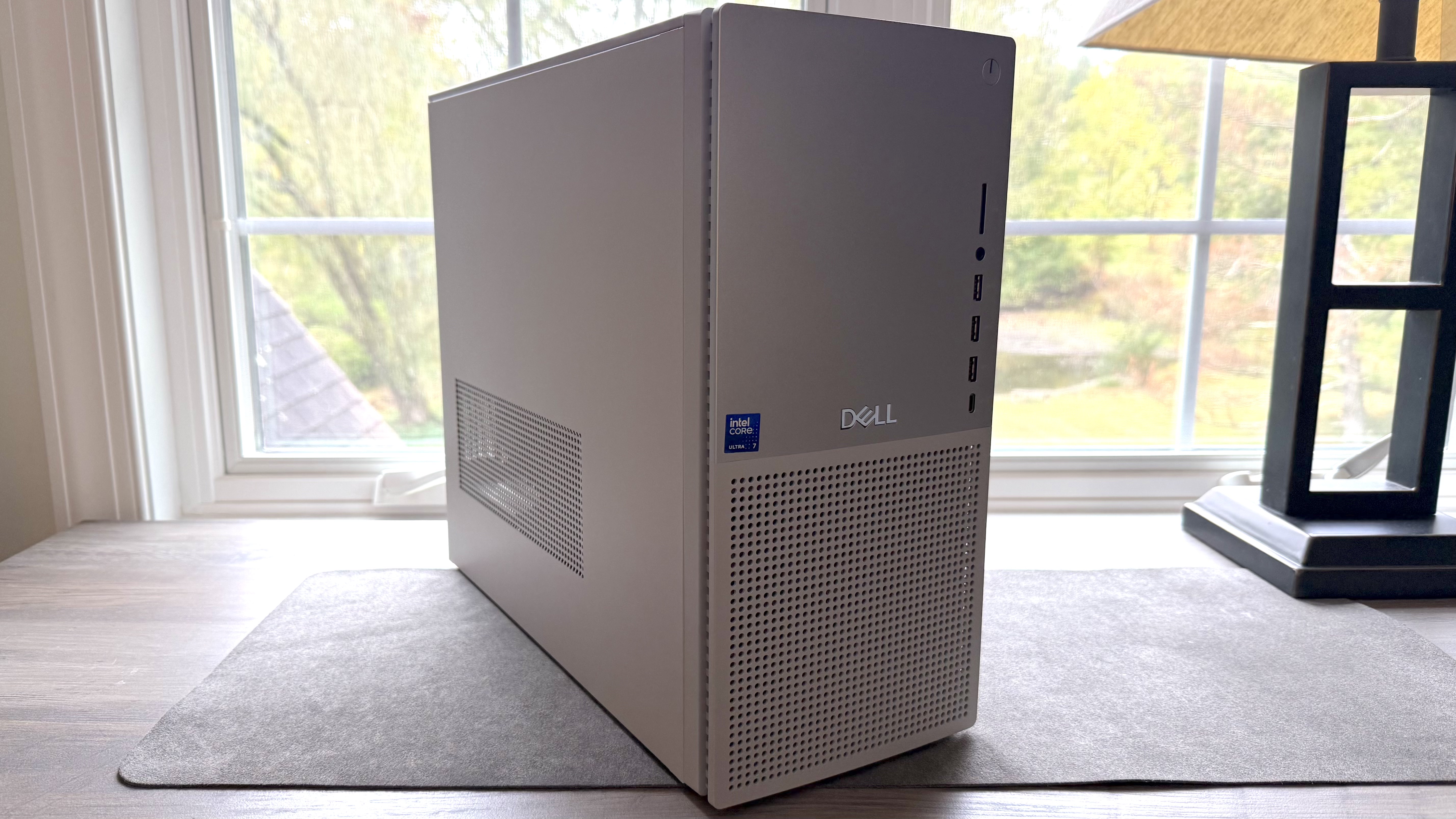 Dell Tower Plus desktop resting on a desk in front of a window